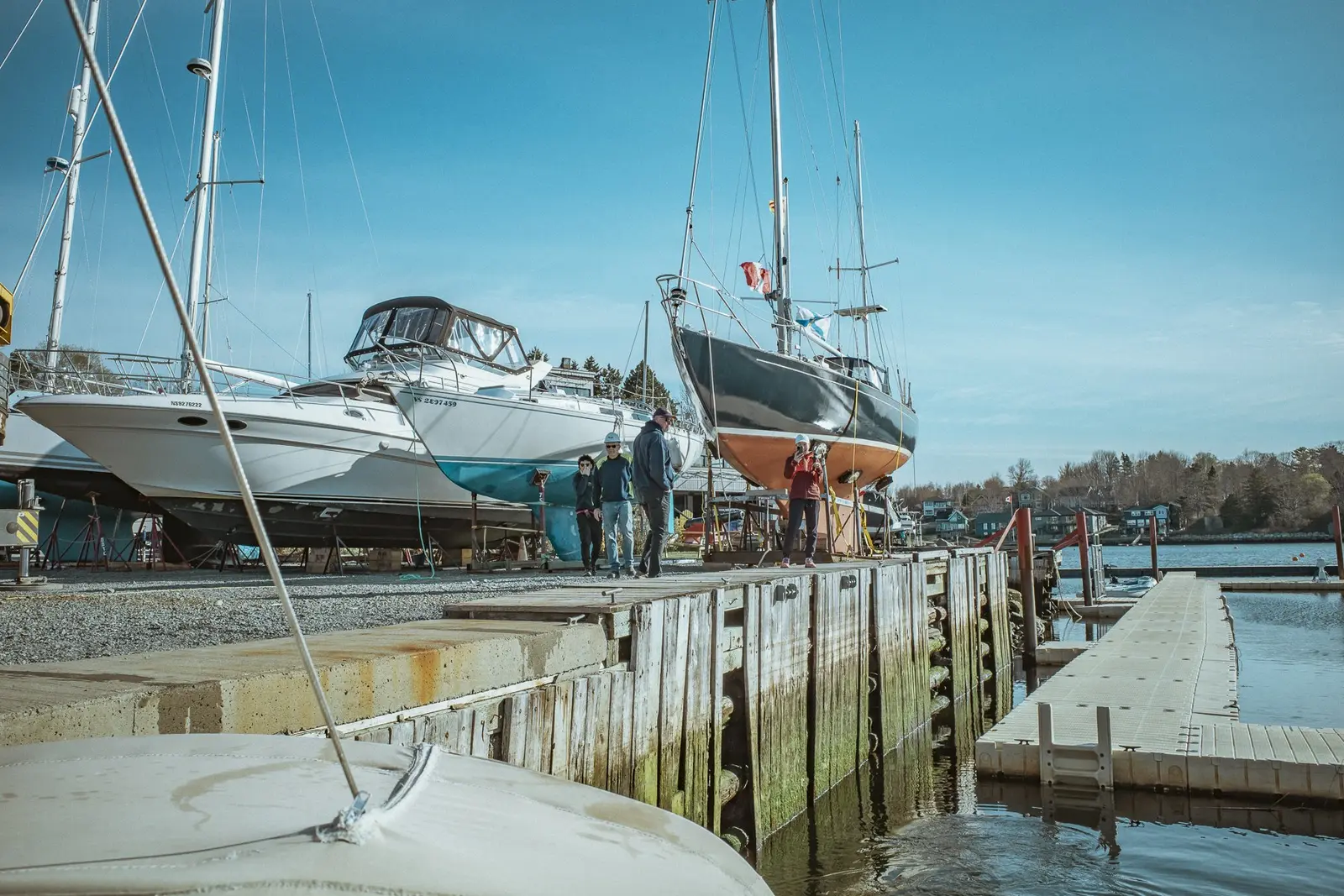 People working beside boats on the club waterfront