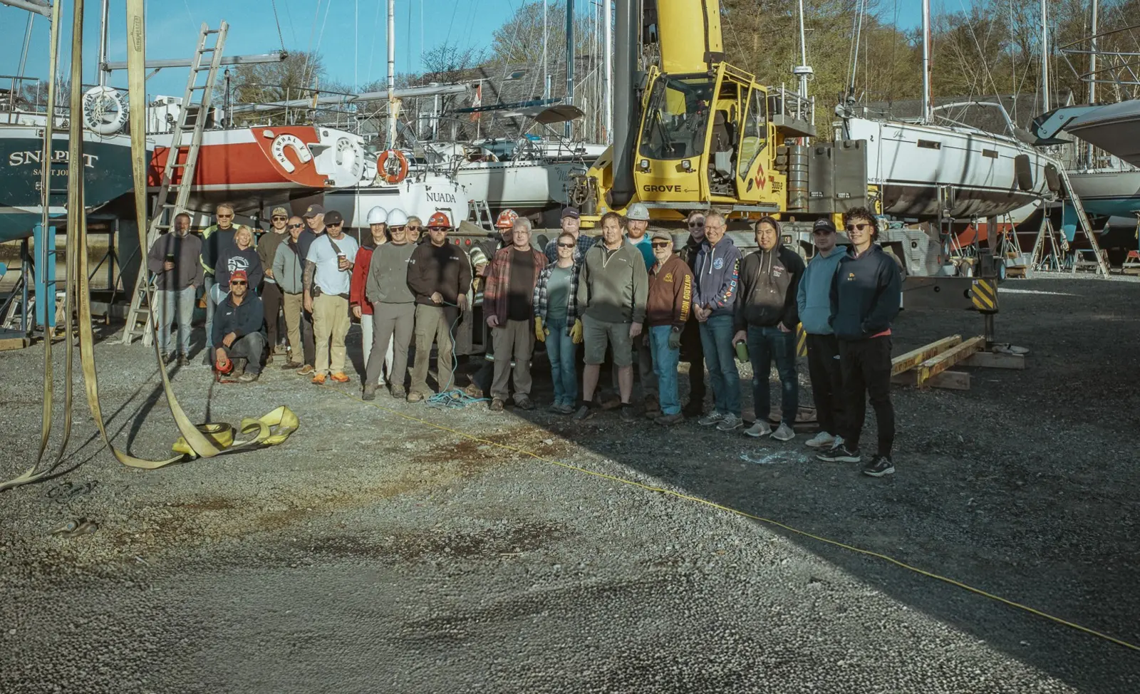 Club members and yard crew gathered together beside their boats
