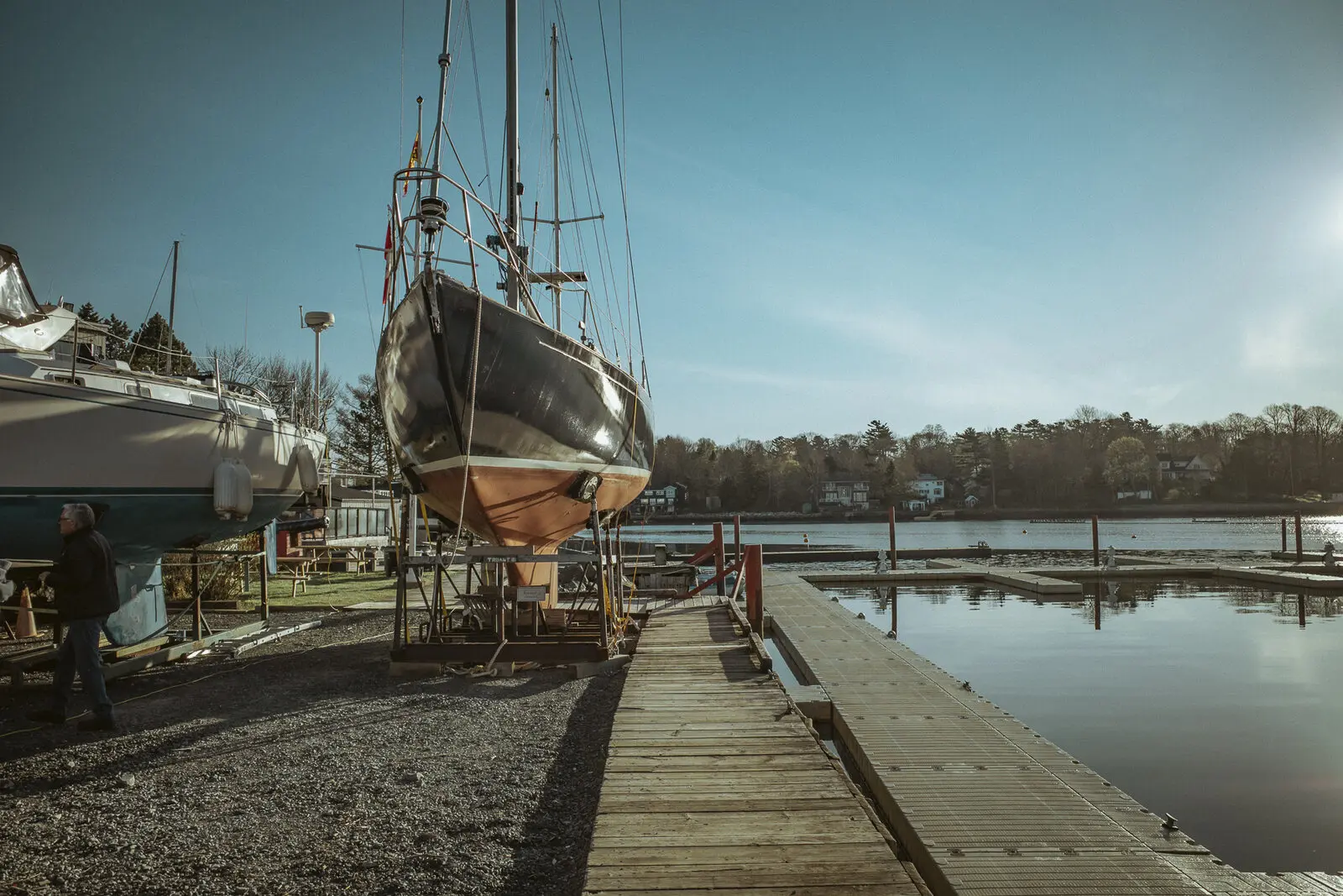 Club crew working around a boatyard crane at haul-out
